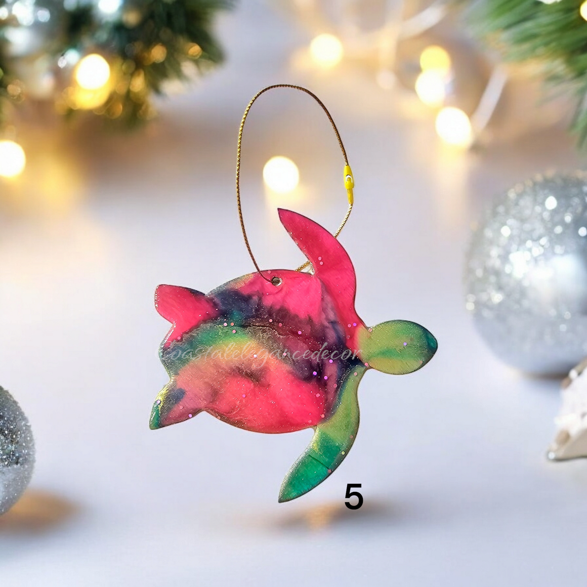 A colorful handmade resin on wood sea turtle ornament with shiny metallic accents, perfect for holiday decor.