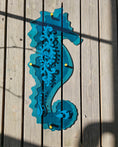 Load image into Gallery viewer, Custom engraved Teal Seahorse outdoor wall art by Coastal Elegance Decor, 1/4 inch transparent acrylic in sea-glass teal for coastal patio decor.
