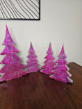 Load image into Gallery viewer, Set of Hot Pink Silver Evergreen Christmas Trees Mantel Sitter Holiday Tabletop Decoration in three various sizes.
