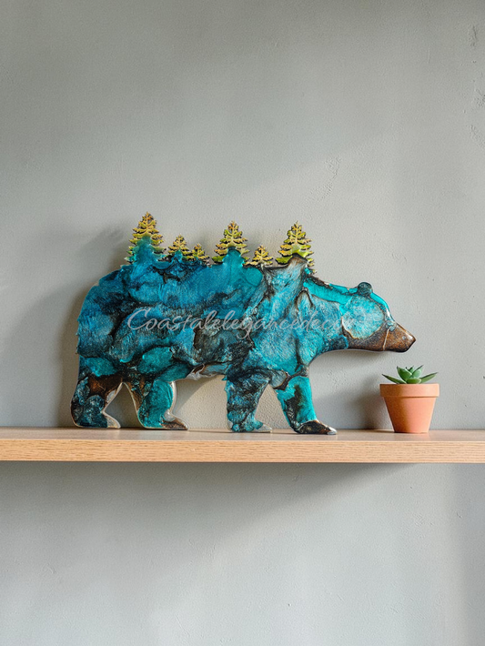 Shimmery silver and teal handmade resin bear with tree cutouts.