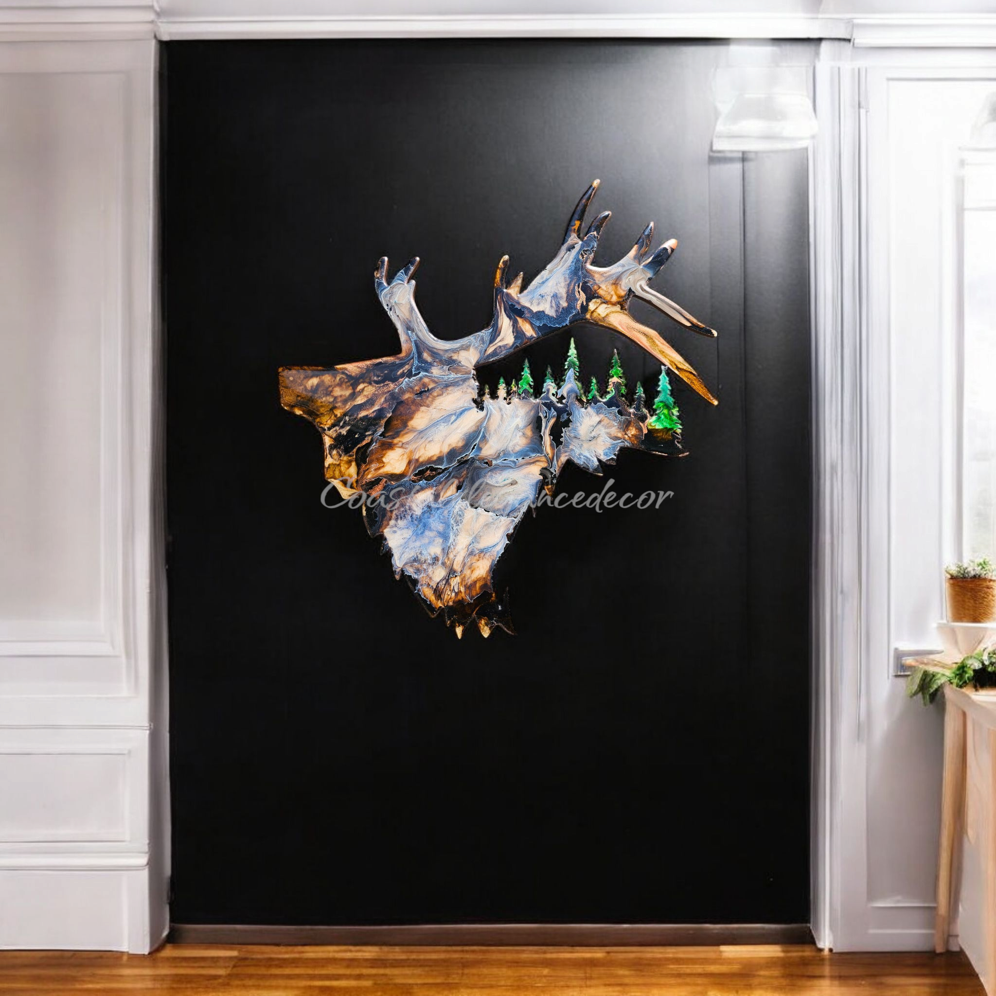 A beautifully handcrafted wildlife art piece featuring an elk with tree cutouts, made from handmade resin on wood, showcasing vibrant colors in greens, blues, and browns, perfect for rustic cabin decor.