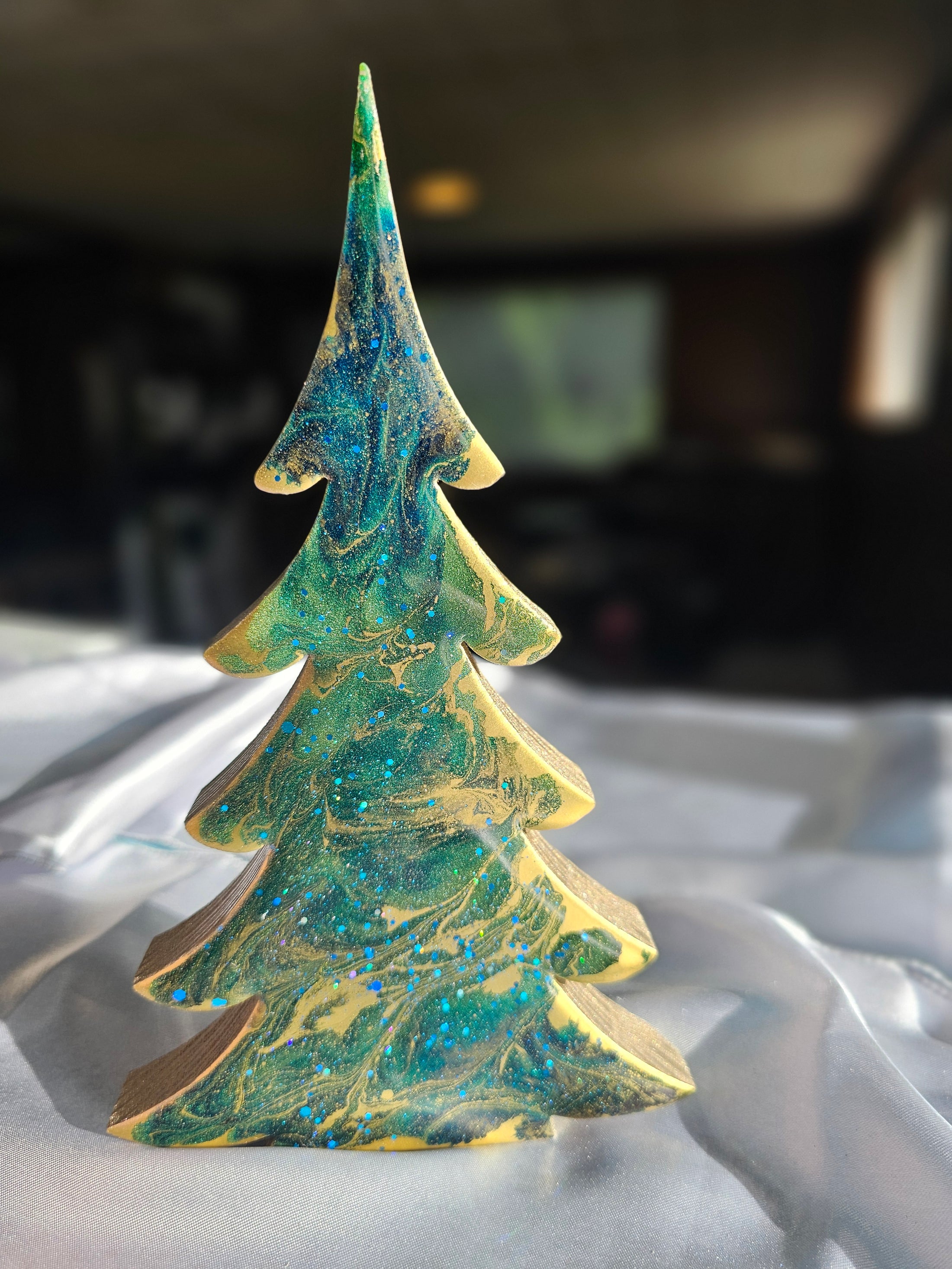 Artistic view of Handcrafted Blue-Green Tabletop Sparkly Christmas Trees 8 Inches portraying the glittery finish and signature by the artist.