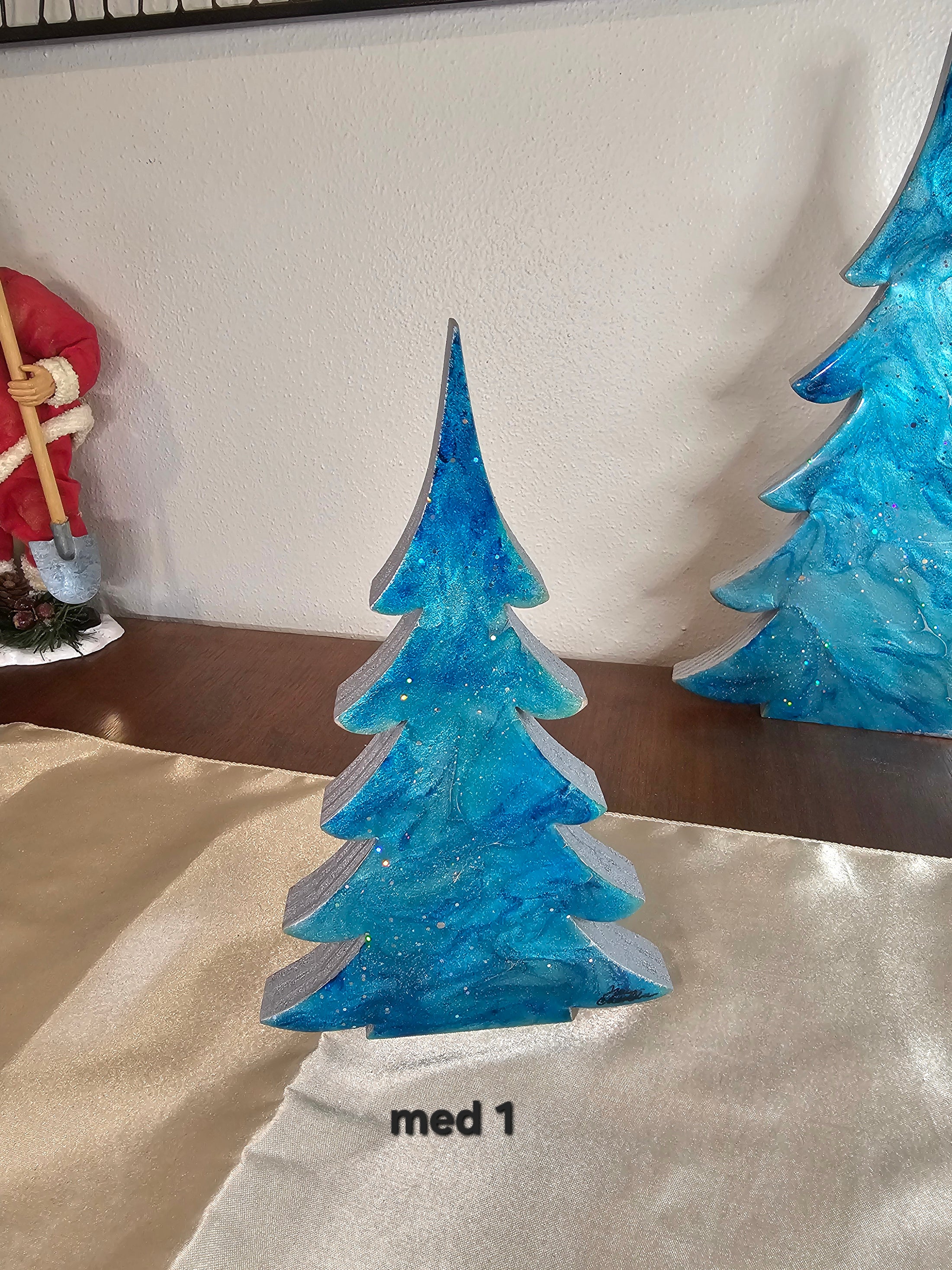 Charming 12-inch Shimmery Silver Blue Evergreen Wood Christmas Trees Holiday Mantelpiece featuring a unique design with silver shimmer glaze, ideal for holiday tabletop decoration.