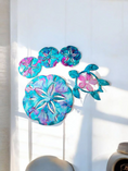 Load image into Gallery viewer, Vibrantly colored handmade resin on wood sand dollar wall decoration showcasing teal, turquoise, and pink hues, perfect for beach home decor.
