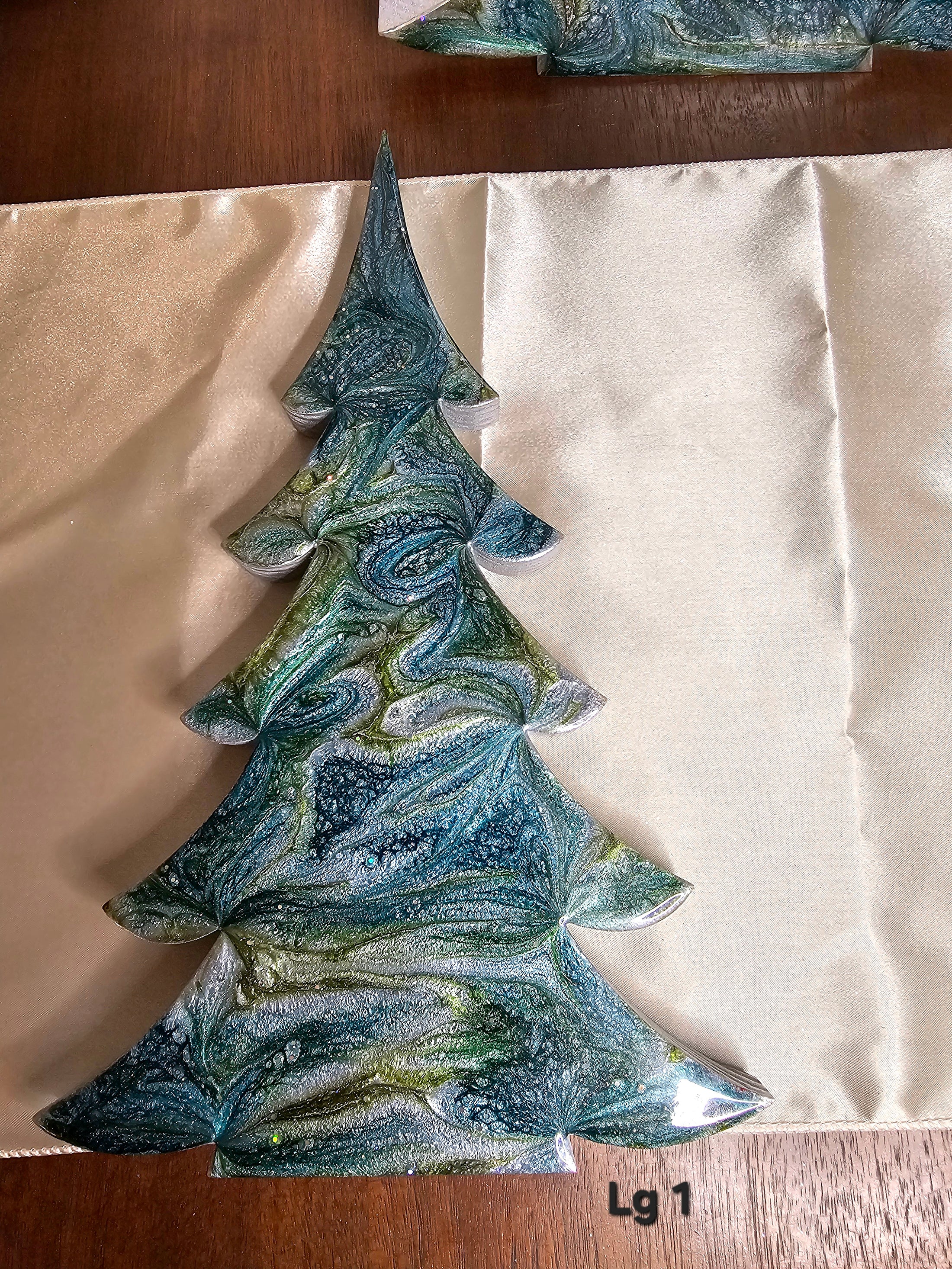 Collection of Handmade Green and Silver Resin Wood Christmas Trees Holiday Mantelpiece in three sizes, displaying handcrafted beauty and holiday charm.