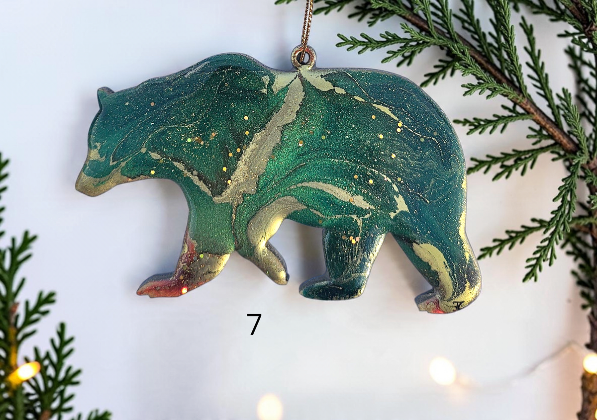 Handmade green resin bear Christmas ornament with white background and boughs 
