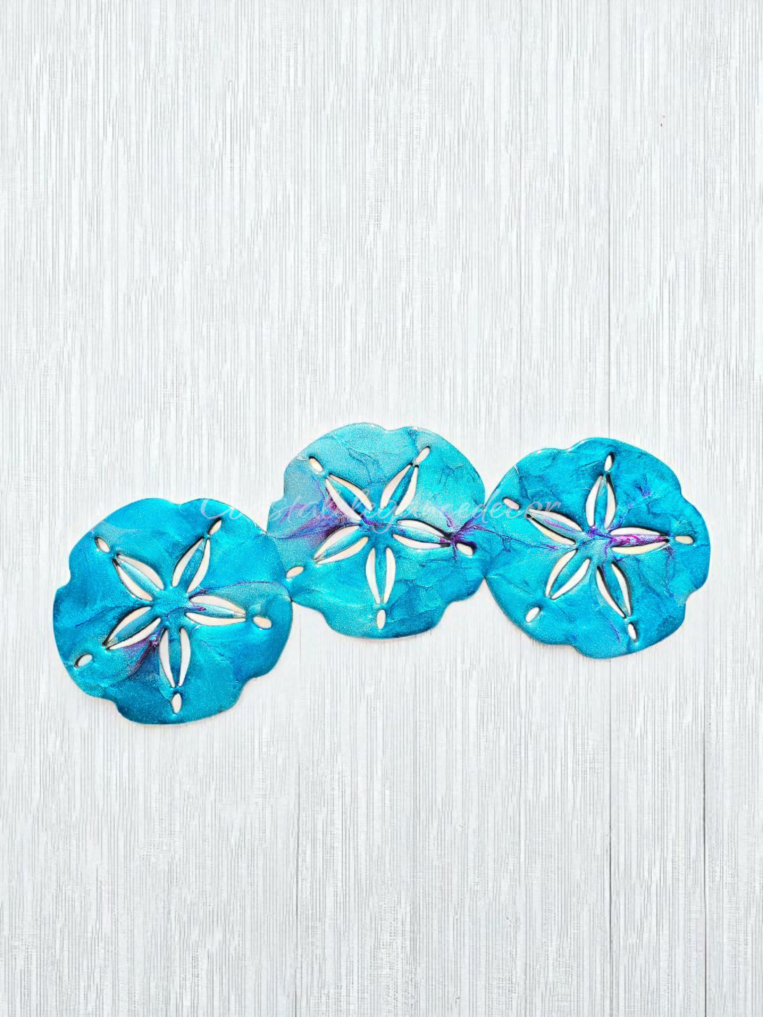 Customizable Sand Dollar Trio Wall Beachy Decoration showcasing bright orange colors and a stylish metallic silver finish for coastal elegance.