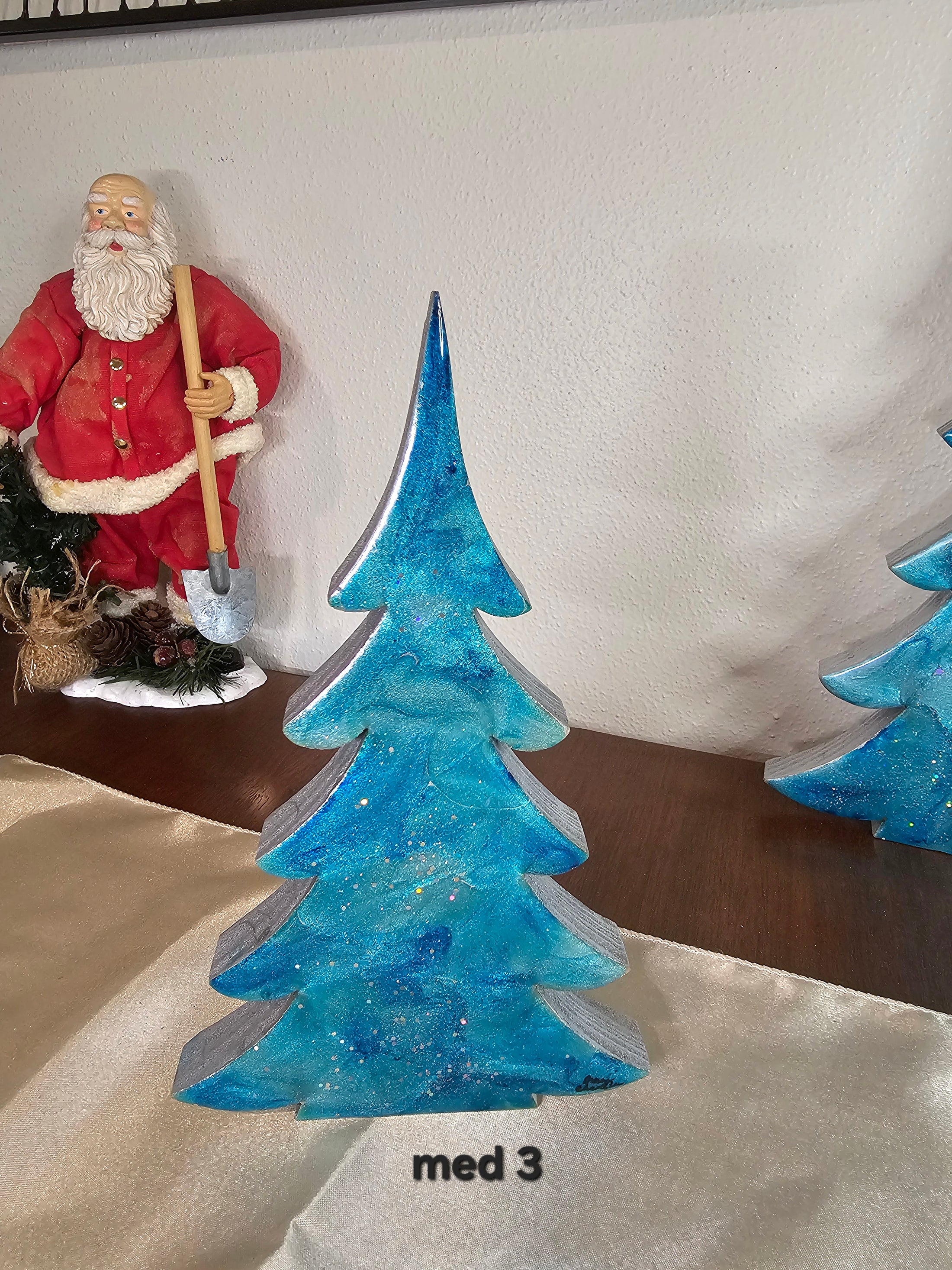 Delightful 8-inch Shimmery Silver Blue Evergreen Wood Christmas Trees Holiday Mantelpiece showcasing intricate patterns, a lovely addition to your Christmas decor.