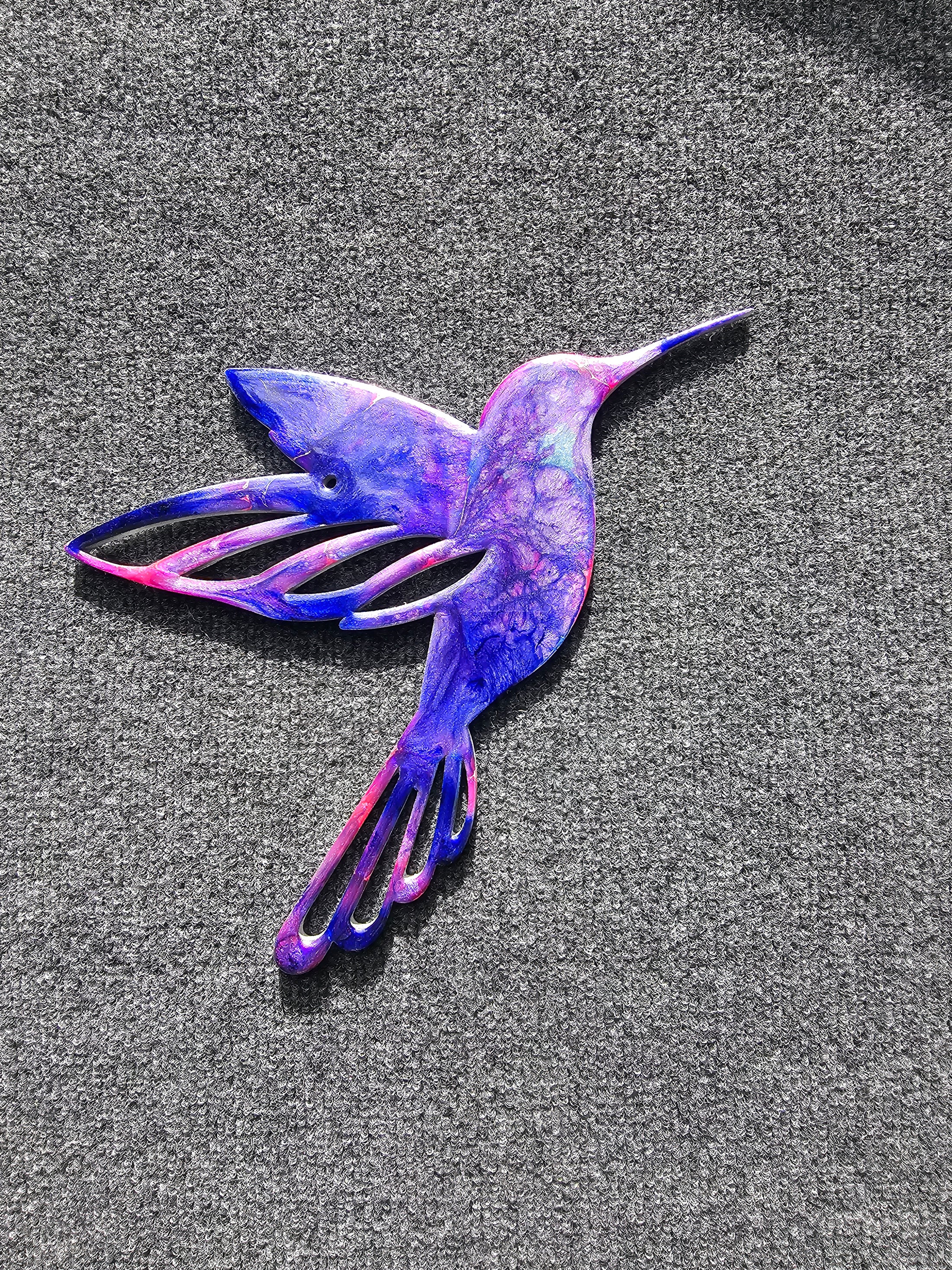 Beautifully designed hummingbird wall art made from handmade resin on wood, adding a touch of elegance to any indoor setting.