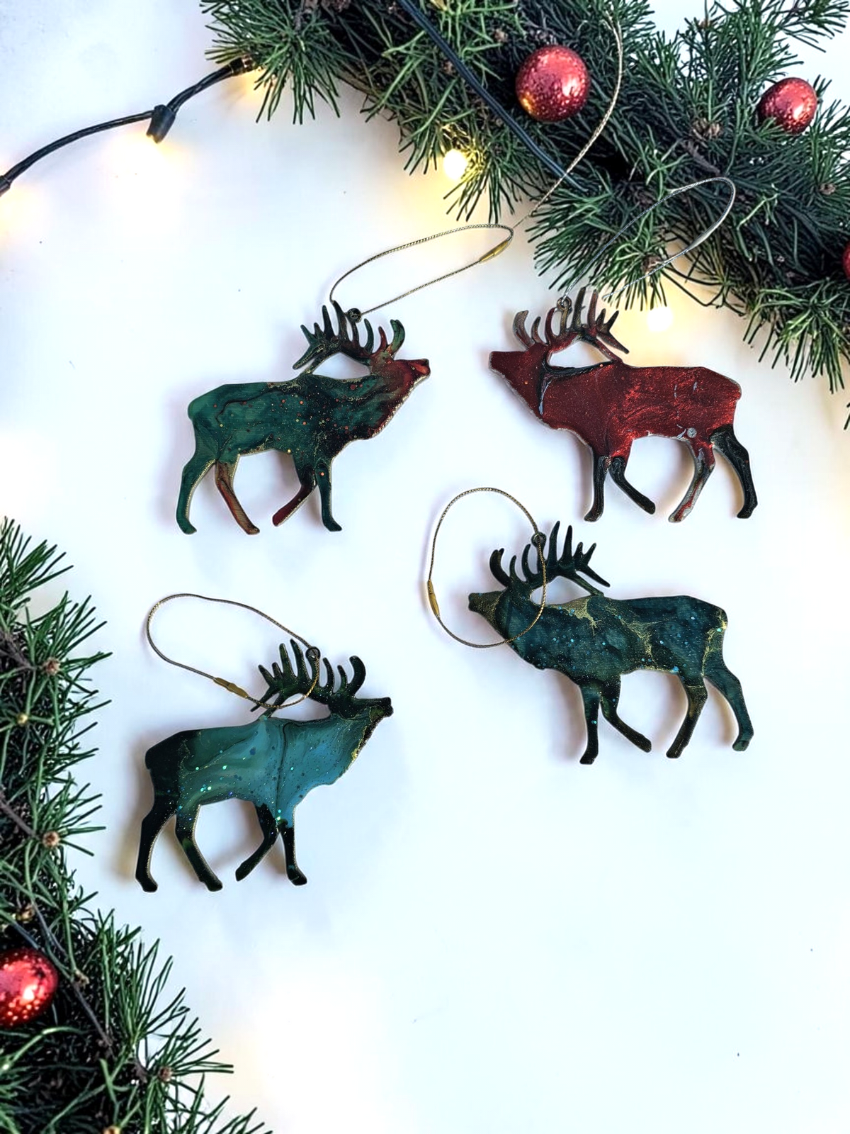 Handmade elk Christmas ornaments with lights and boughs