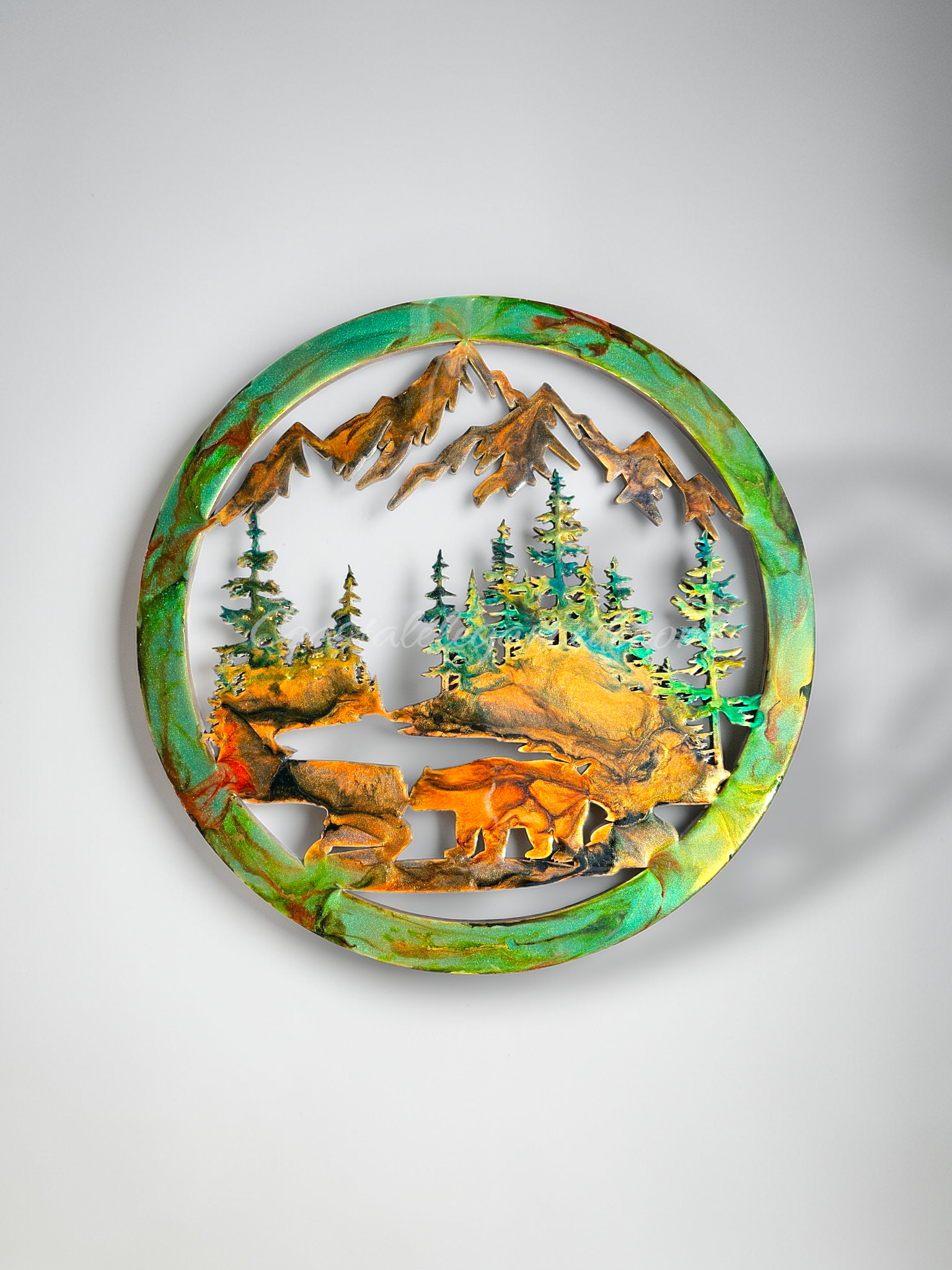Handmade 15.5-inch resin on wood wall art featuring a bear at the water with fir trees and mountains, metallic accents, rustic nature-inspired décor.