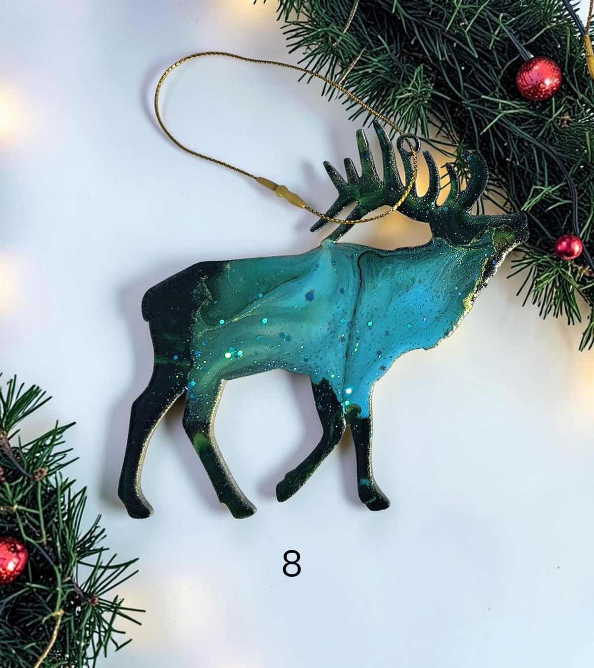 Handmade elk Christmas ornaments with lights and boughs