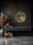Load image into Gallery viewer, Handmade 15.5-inch resin on wood wall art featuring a bear at the water with fir trees and mountains, metallic accents, rustic nature-inspired décor hanging on a dark wall above a credenza.
