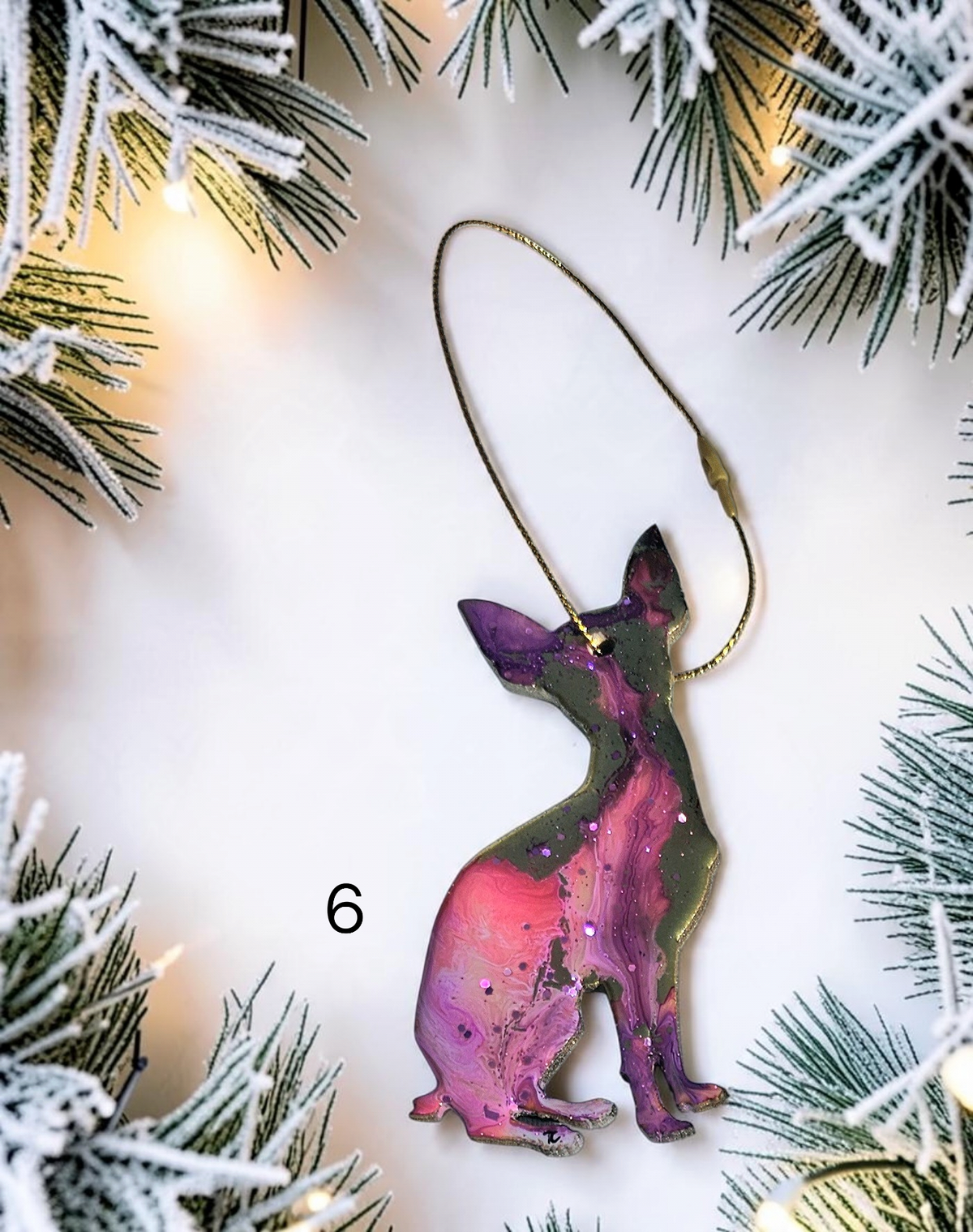 Pink Chihuahua dog ornament on a white background with Christmas lights 