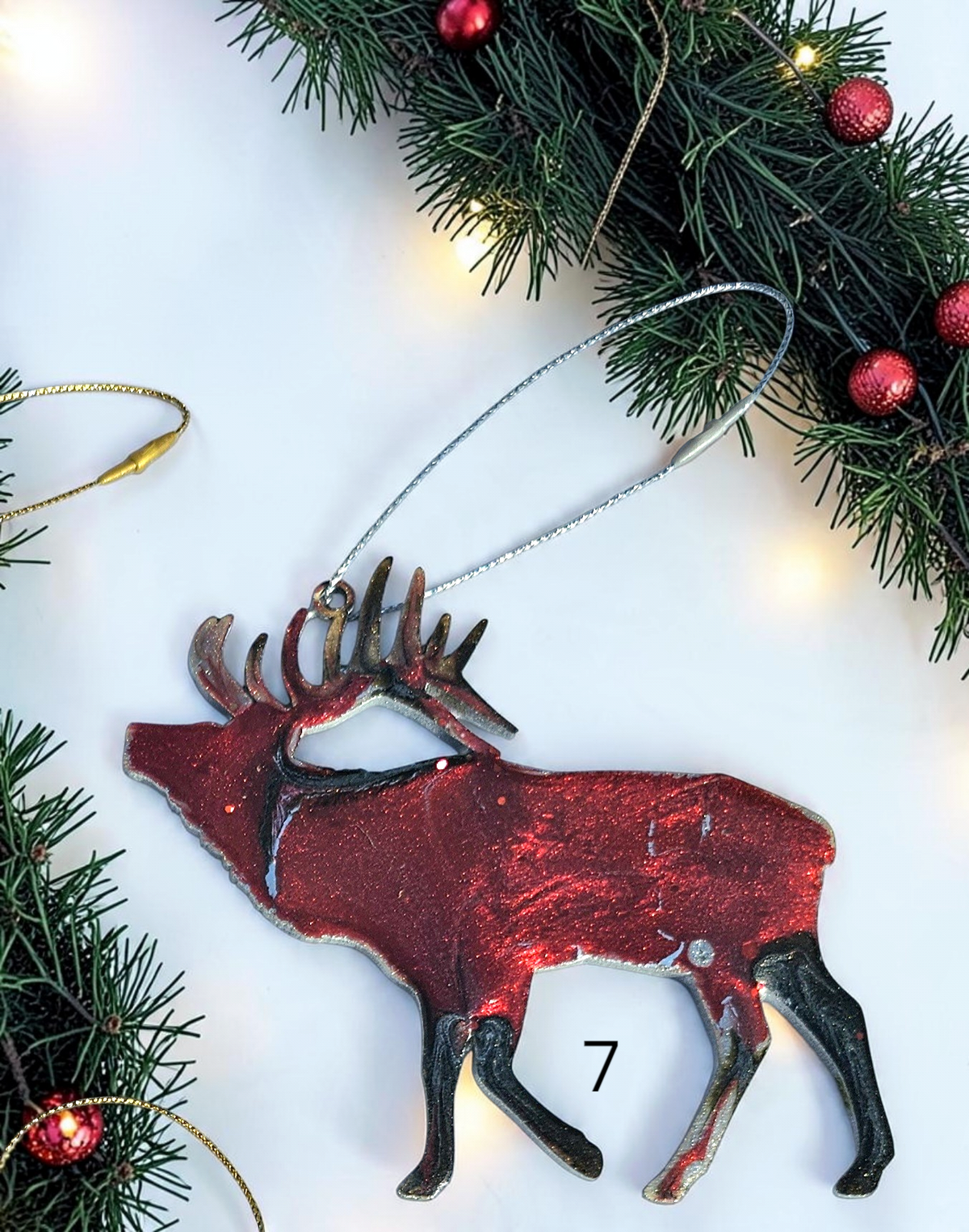 Handmade elk Christmas ornaments with lights and boughs