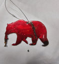 Load image into Gallery viewer, Close-up of Handmade Grizzly Bear Christmas Ornament with Salmon - Rustic Wildlife Cabin Decor showcasing intricate details and craftsmanship.
