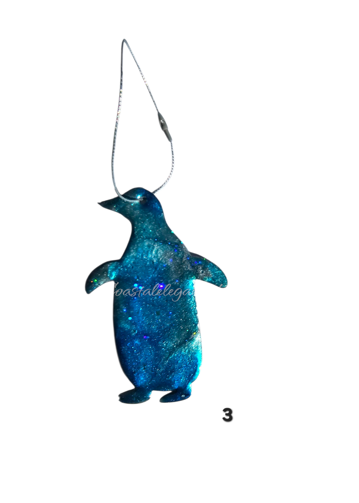 Blue glittery penguin ornament on a white background